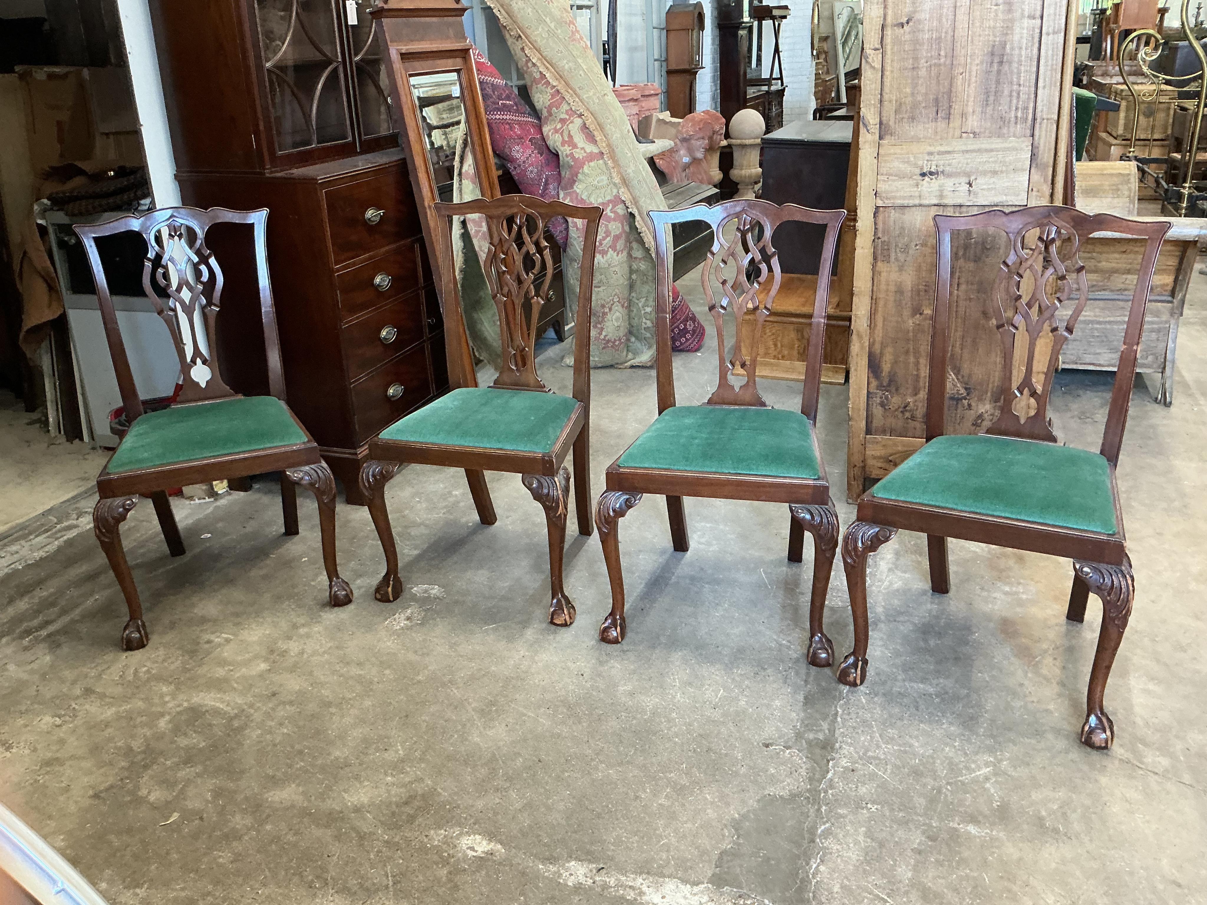 A Chippendale Revival mahogany extending dining table, 210cm extended, two spare leaves, depth 106cm, height 74cm together with a set of six Chippendale Revival mahogany dining chairs, two with arms